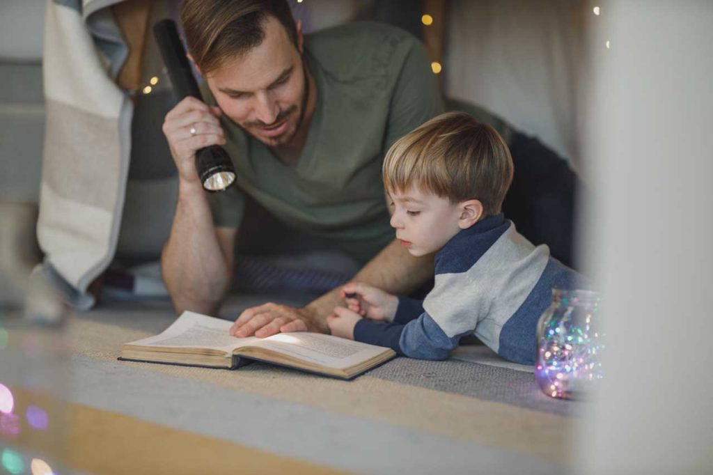 Parent and child reading a book together