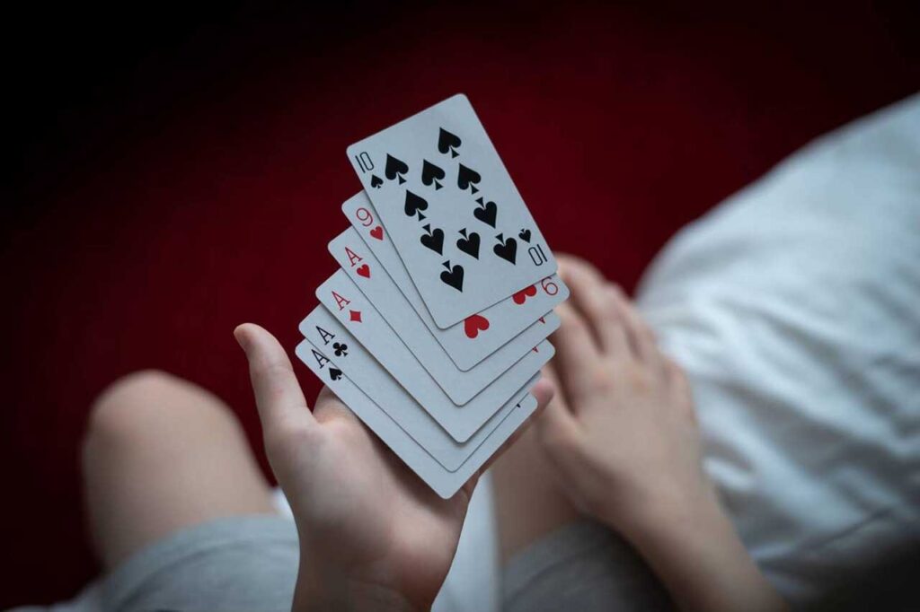 Kid holding playing cards